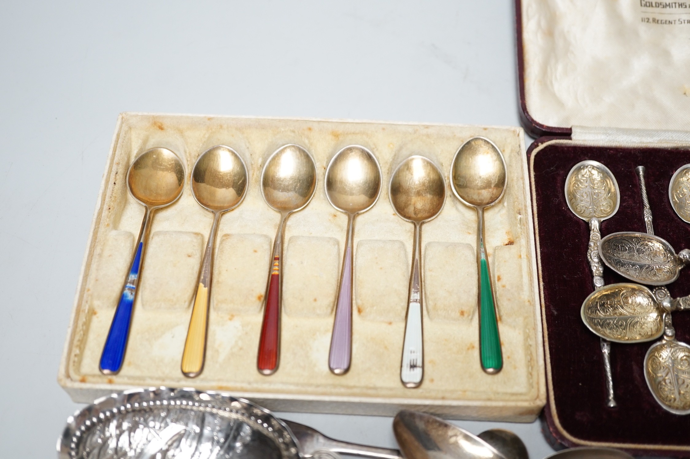 A pair of George V silver grape shears, George Howson, Sheffield, 1912, together with a small quantity of silver and white metal flatware including a set of six continental 925 and enamel coffee spoons.